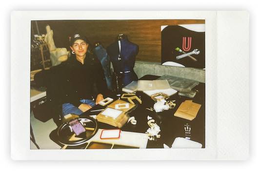 A woman sitting at her workshop desk 