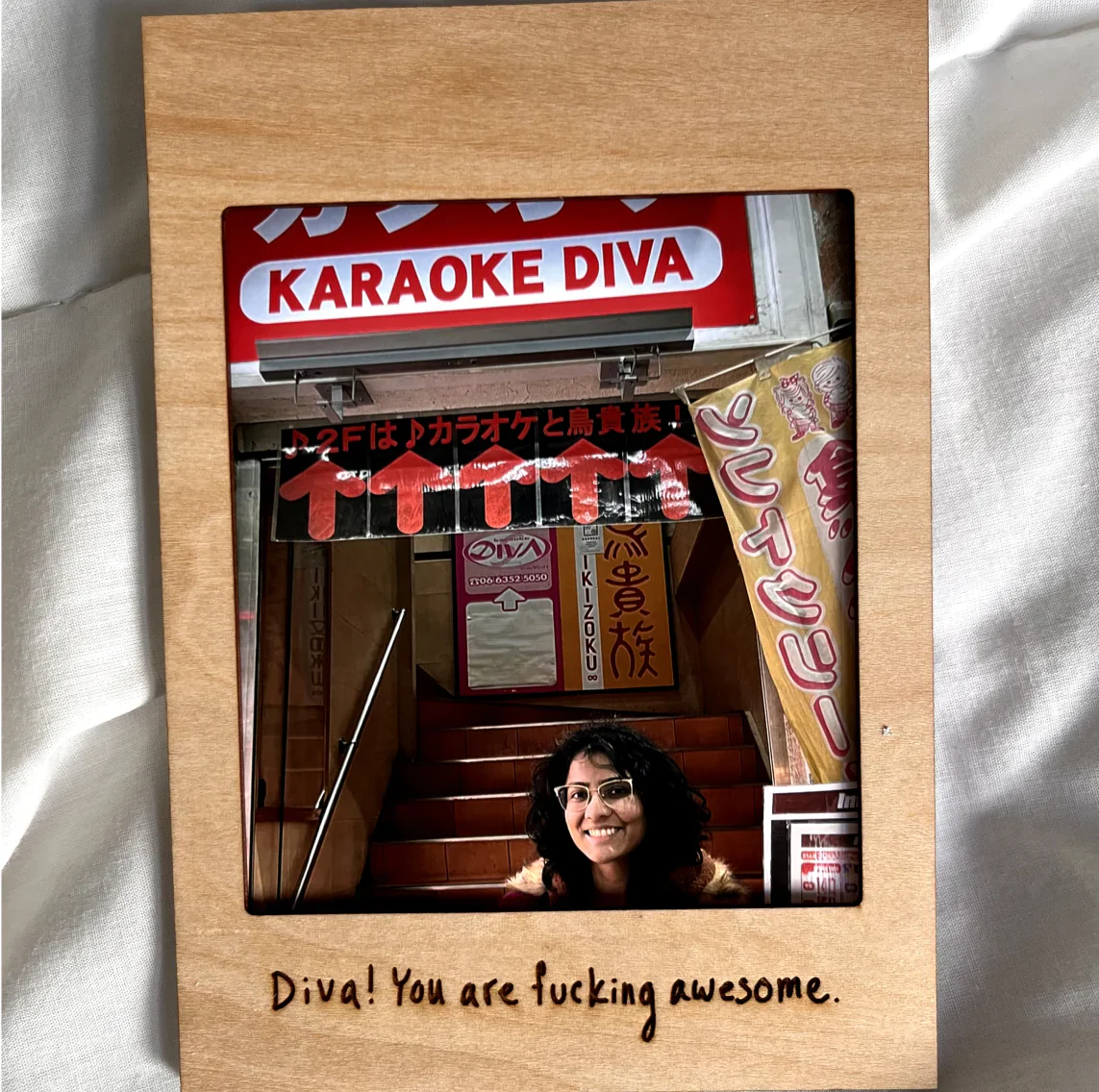 Wooden Pop-up Frame with a karaoke-night photo and a handwritten note